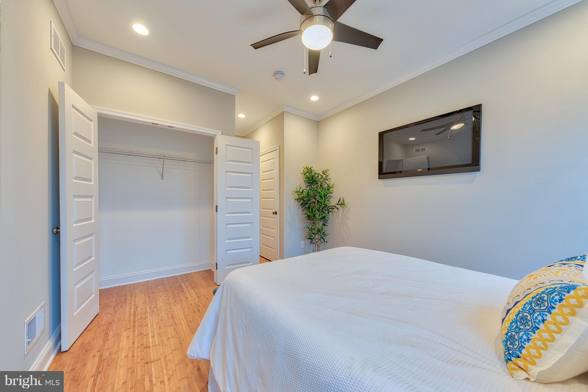 115 North Decker Avenue Baltimore, MD 21224 - Photo 24 of 30 a bedroom with a bed and a flat screen tv