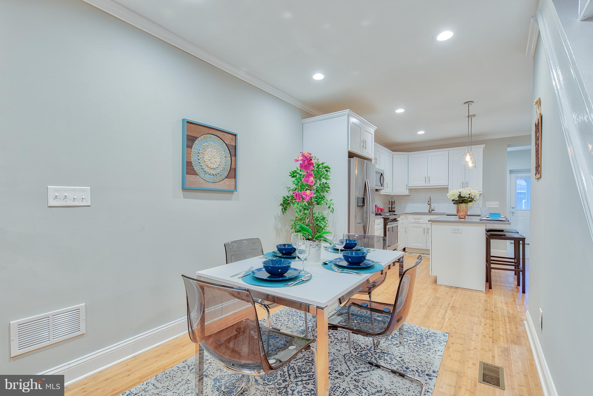 115 North Decker Avenue Baltimore, MD 21224 - Photo 6 of 30 a view of a dining room with furniture window and wooden floor