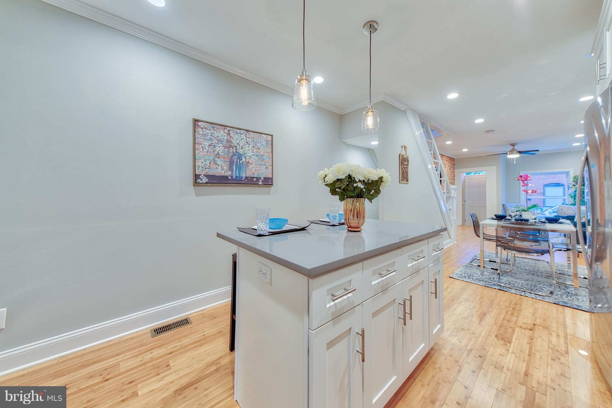 115 North Decker Avenue Baltimore, MD 21224 - Photo 10 of 30 a kitchen with a sink a counter top space and living room view