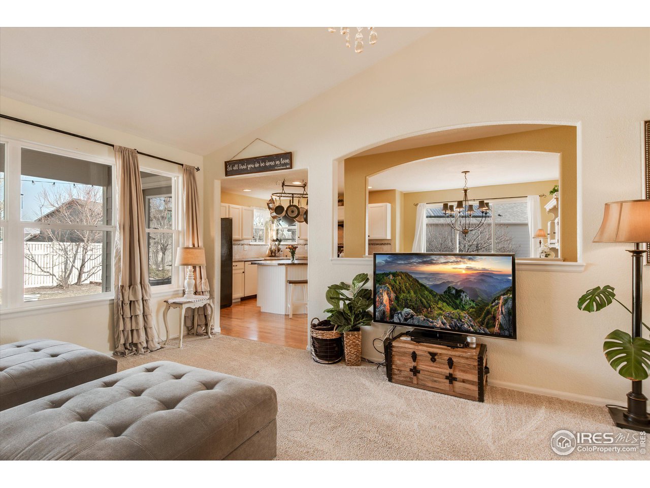 5771 Mountain Shadows Boulevard Firestone, CO 80504 - Photo 12 of 40 a living room with furniture a rug and a large window