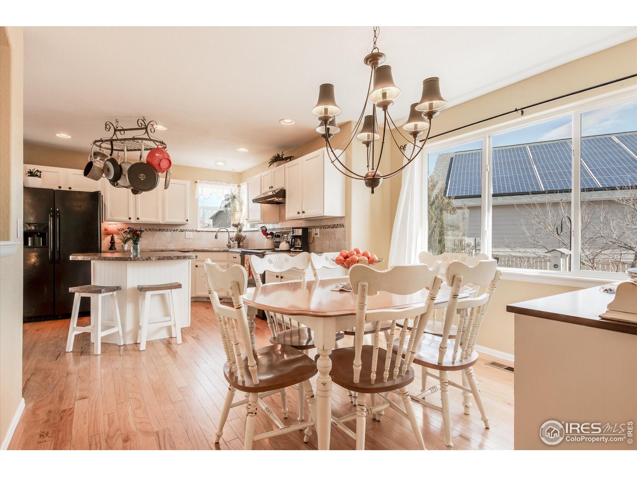 5771 Mountain Shadows Boulevard Firestone, CO 80504 - Photo 16 of 40 a view of a dining room with furniture and wooden floor