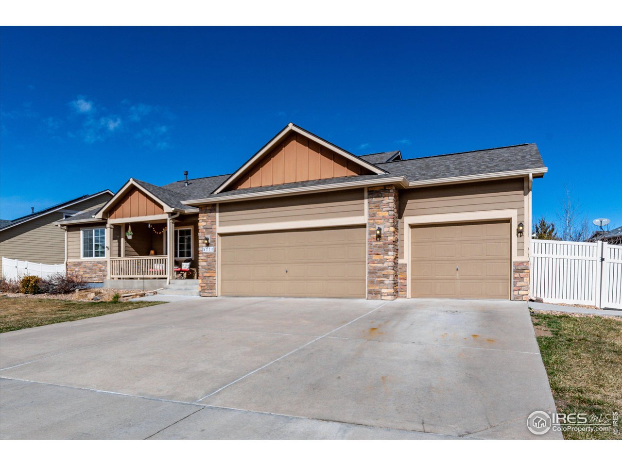 5771 Mountain Shadows Boulevard Firestone, CO 80504 - Photo 3 of 40 a front view of a house with a yard and garage