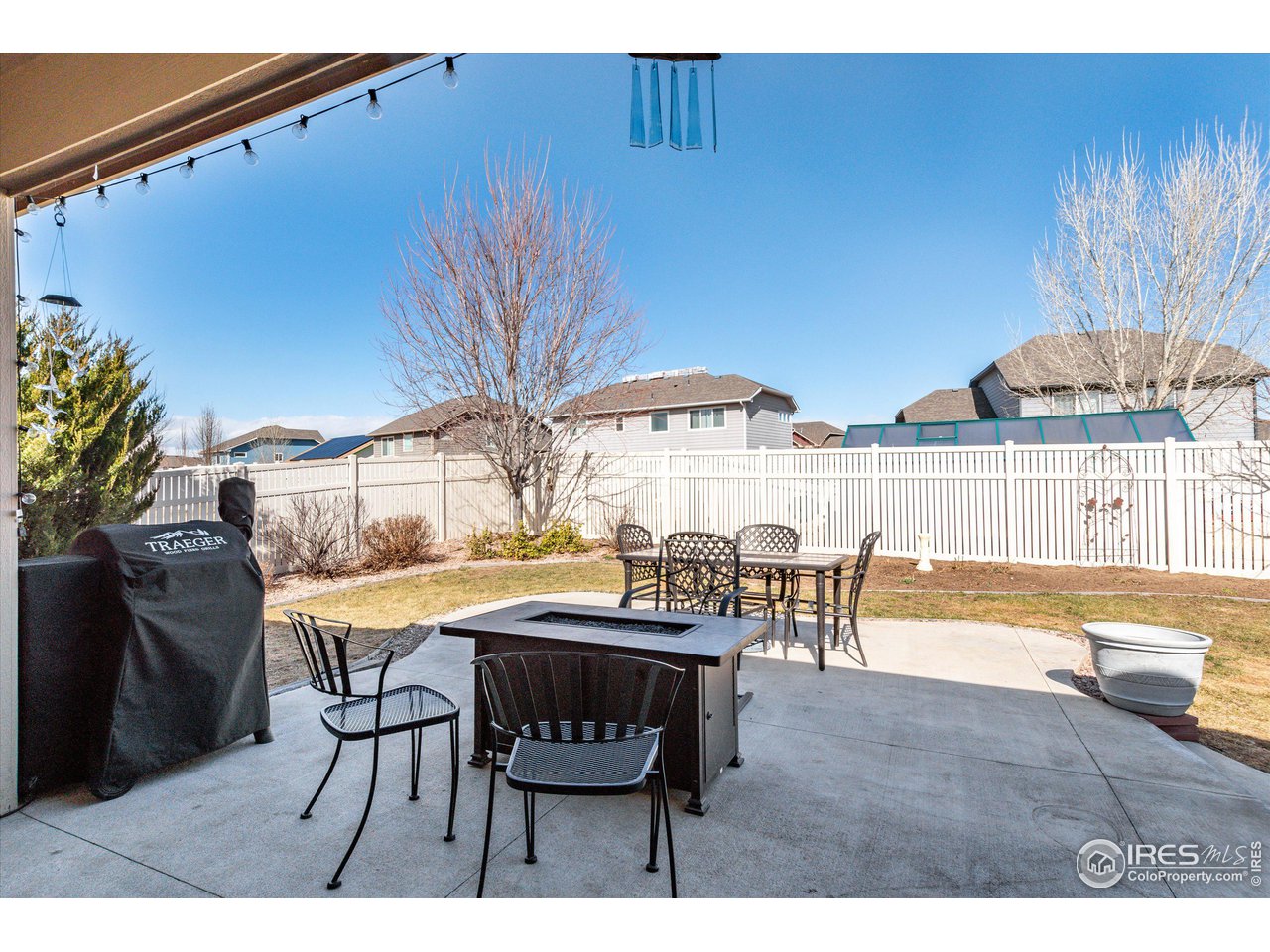 5771 Mountain Shadows Boulevard Firestone, CO 80504 - Photo 34 of 40 a view of a dining room with furniture and chandelier
