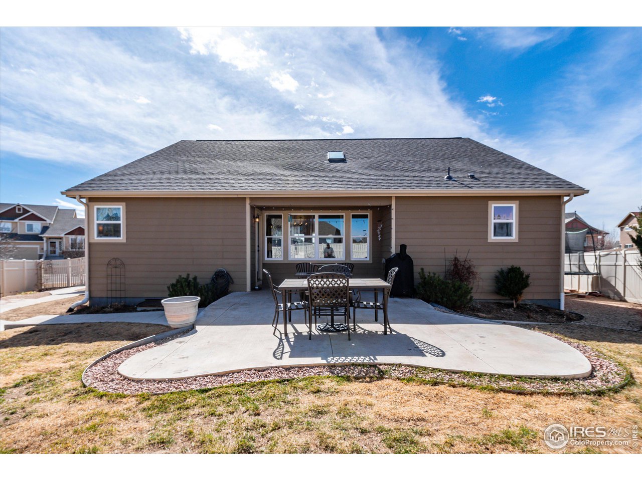 5771 Mountain Shadows Boulevard Firestone, CO 80504 - Photo 38 of 40 a view of a house with dining table and chairs with wooden fence