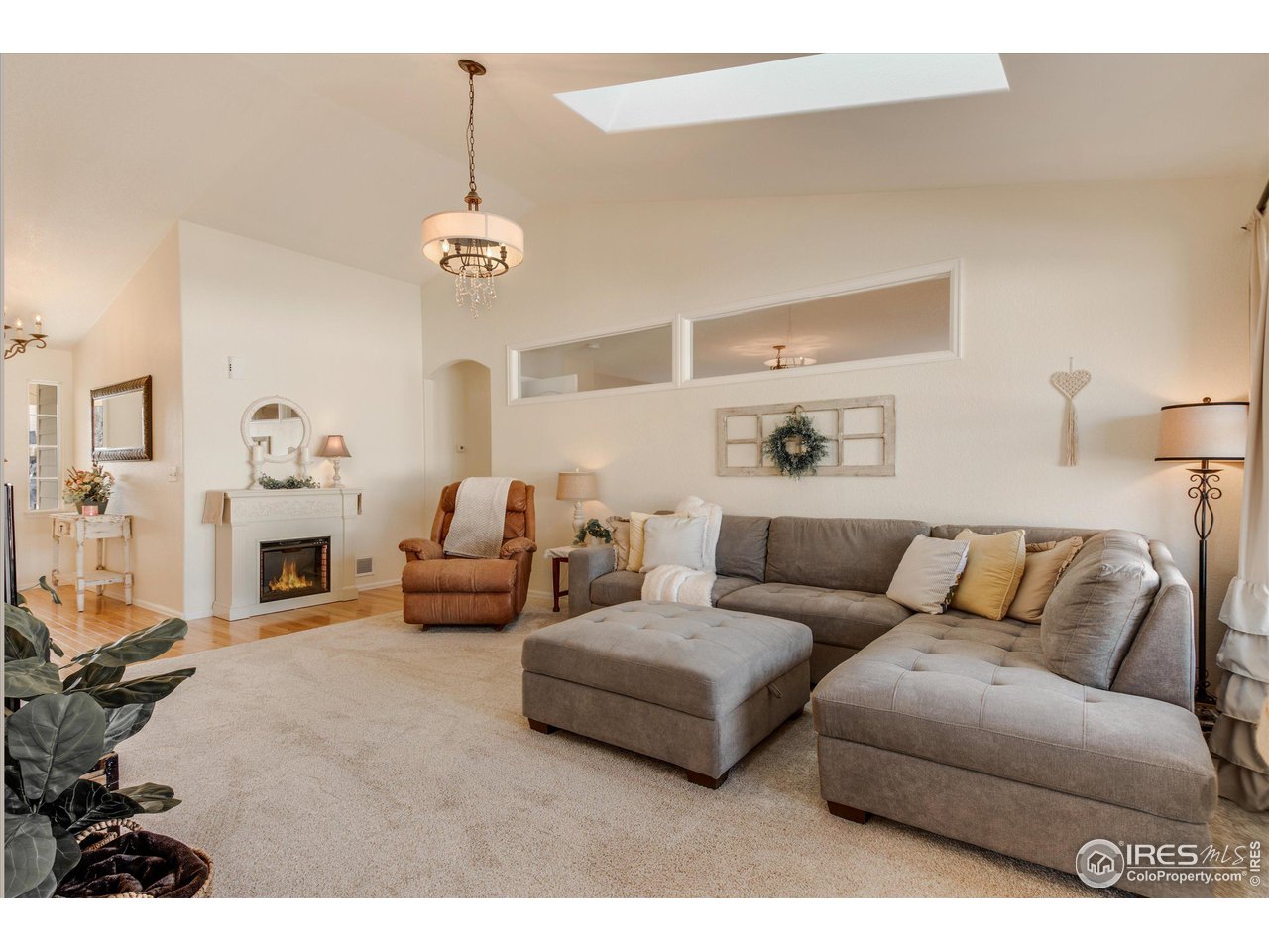5771 Mountain Shadows Boulevard Firestone, CO 80504 - Photo 6 of 40 a living room with furniture and a chandelier