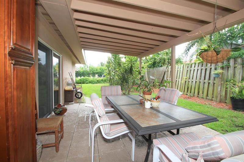 98 Seminole Lane Boca Raton, FL 33487 - Photo 11 of 42 a view of a patio with a table chairs and a backyard