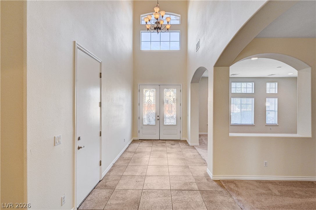 6761 Clay TABLET Street Las Vegas, NV 89149 - Photo 31 of 73 An airy entry foyer showcases towering ceilings, arched transitions, and tile flooring.