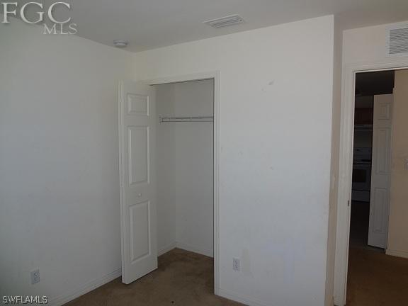 741 Alabama Road South Lehigh Acres, FL 33974 - Photo 3 of 8 a view of hallway with closet