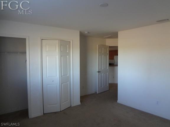 741 Alabama Road South Lehigh Acres, FL 33974 - Photo 4 of 8 an empty room with windows