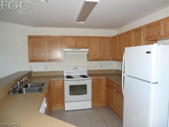 741 Alabama Road South Lehigh Acres, FL 33974 - Photo 6 of 8 a white refrigerator freezer sitting inside of a kitchen