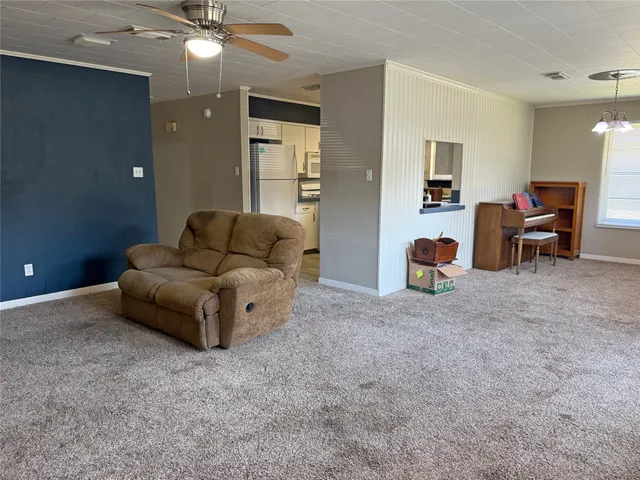 a living room with furniture and a lamp