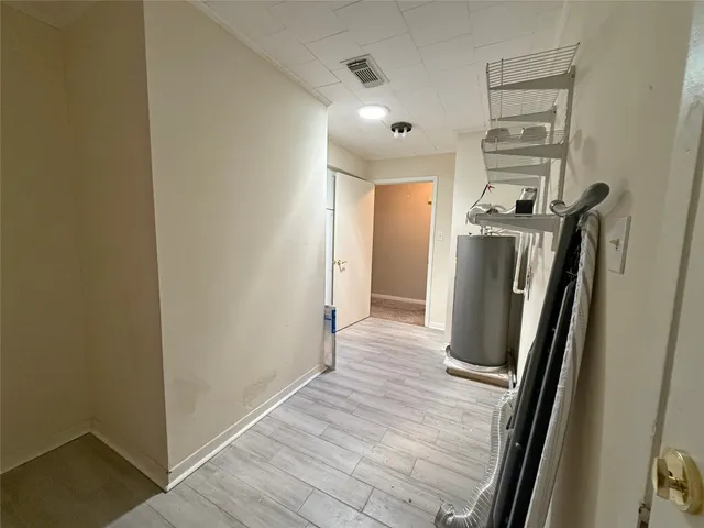 a view of hallway with wooden floor