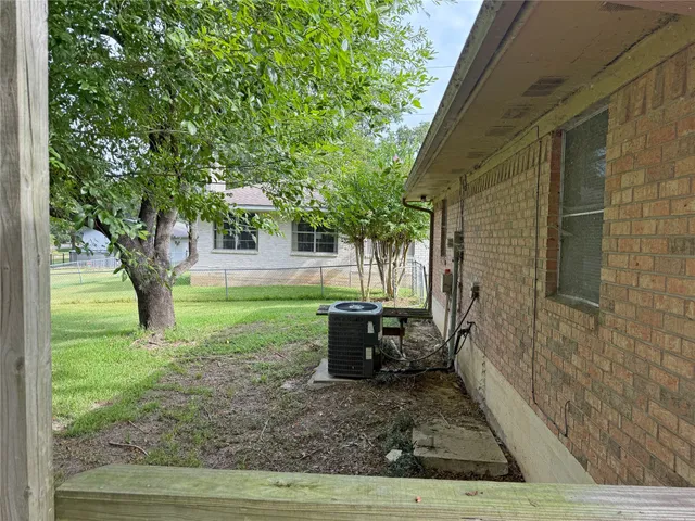a view of a backyard with large trees