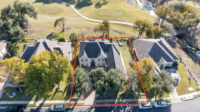 an aerial view of residential houses with outdoor space