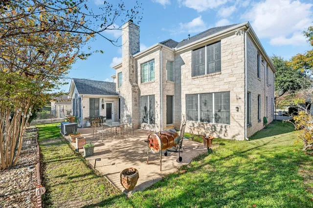 a view of a house with backyard sitting area and garden
