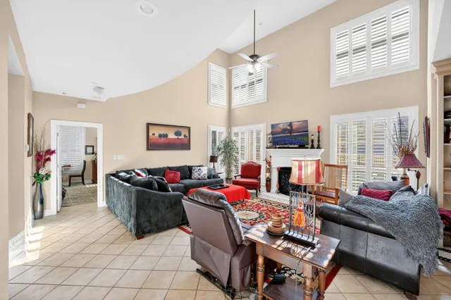 a living room with fireplace furniture and a flat screen tv