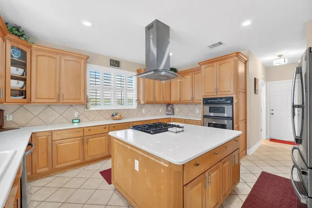 a kitchen that has a sink a stove and a table