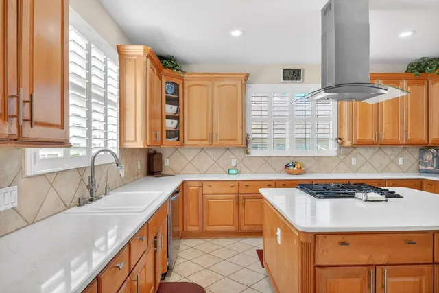 a kitchen with stainless steel appliances granite countertop a sink and a stove