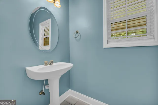 a bathroom with a sink a mirror and a window