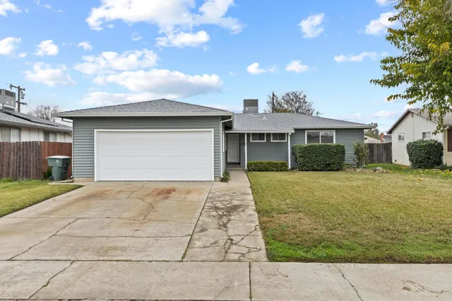 a front view of a house with a garden