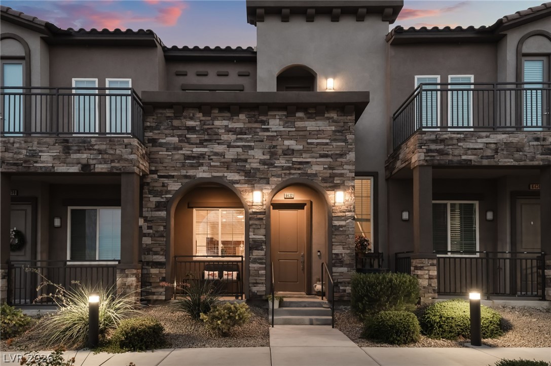 6432 Spring Jog Street Las Vegas, NV 89166 - Photo 49 of 61 Stone facade and wrought iron balconies enhance this multi-level home's inviting curb appeal.