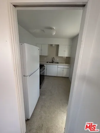 a refrigerator freezer sitting inside of a kitchen