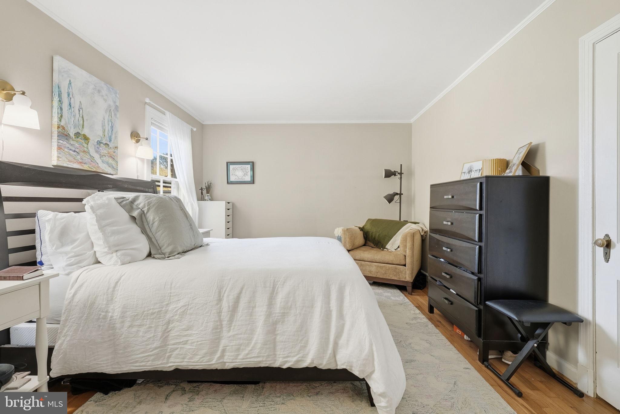 2700 13th Road South, Unit 510 Arlington, VA 22204 - Photo 11 of 17 a bedroom with a bed and a flat tv screen on dresser