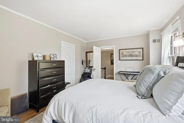 a bedroom with a bed and dresser