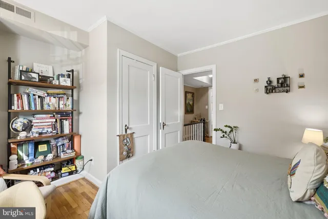 a bedroom with a bed and a book shelf
