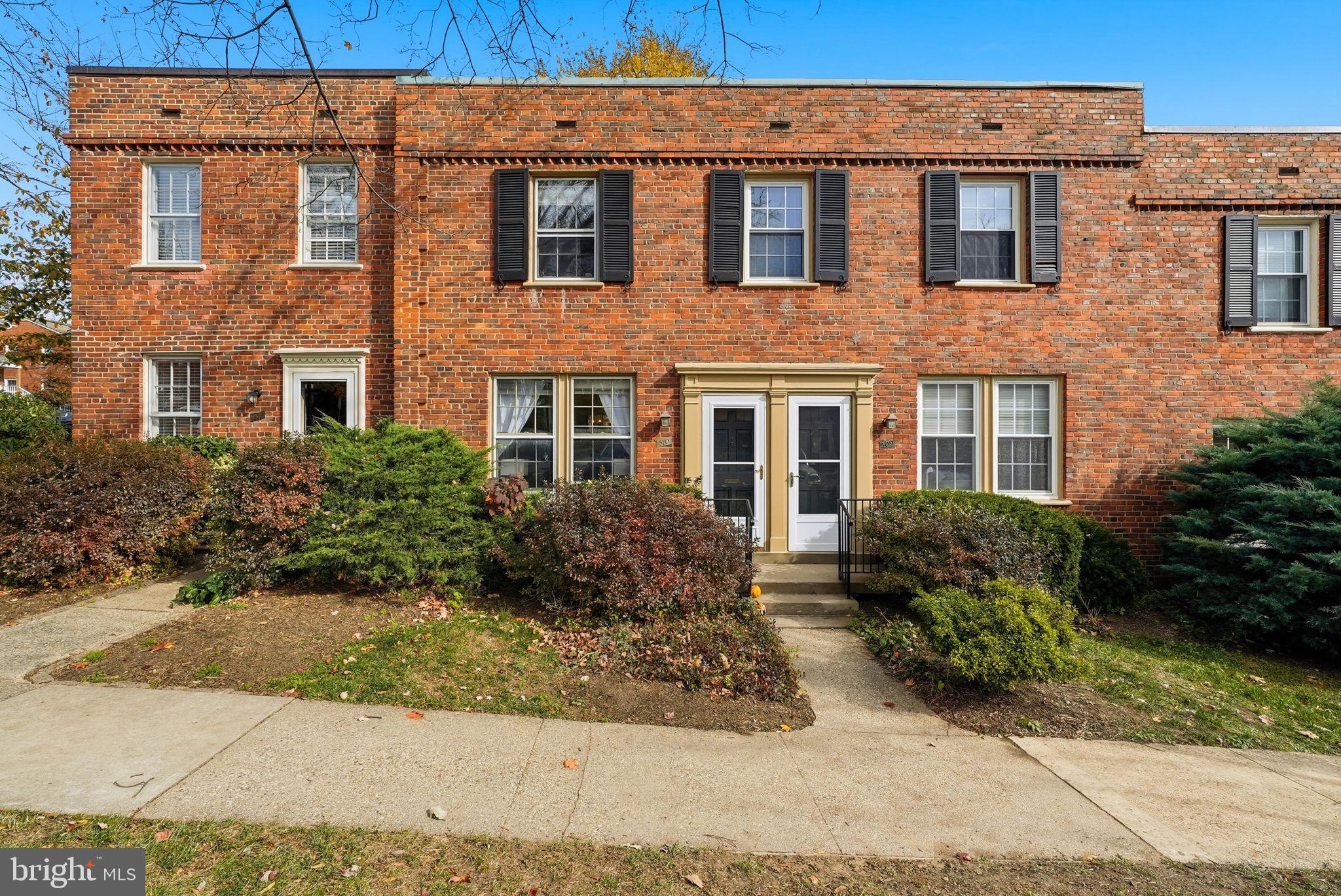2700 13th Road South, Unit 510 Arlington, VA 22204 - Photo 17 of 17 a view of a brick house with many windows next to a yard