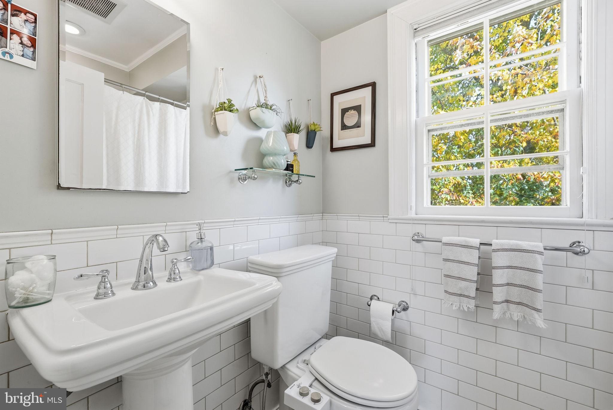 2700 13th Road South, Unit 510 Arlington, VA 22204 - Photo 10 of 17 a bathroom with a sink a toilet and a mirror