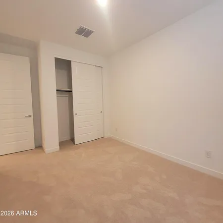 an empty room with closet area