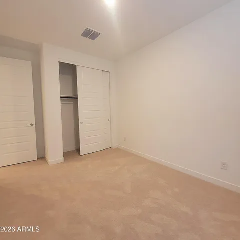 an empty room with closet area