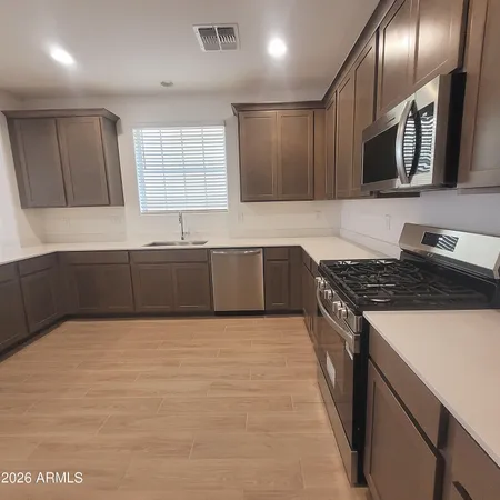a large kitchen with granite countertop a stove and a sink