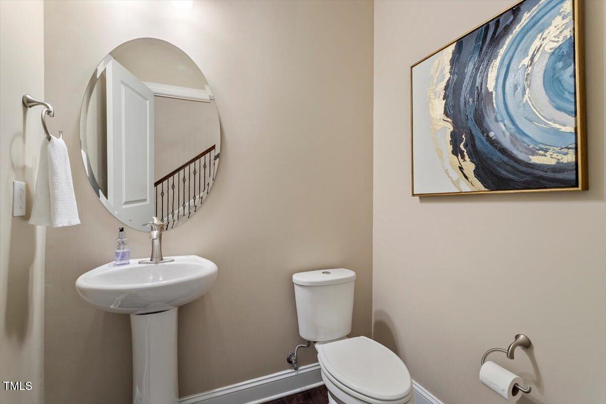 2421 Trenton Park Lane Raleigh, NC 27607 - Photo 15 of 66 a bathroom with a toilet a sink and mirror