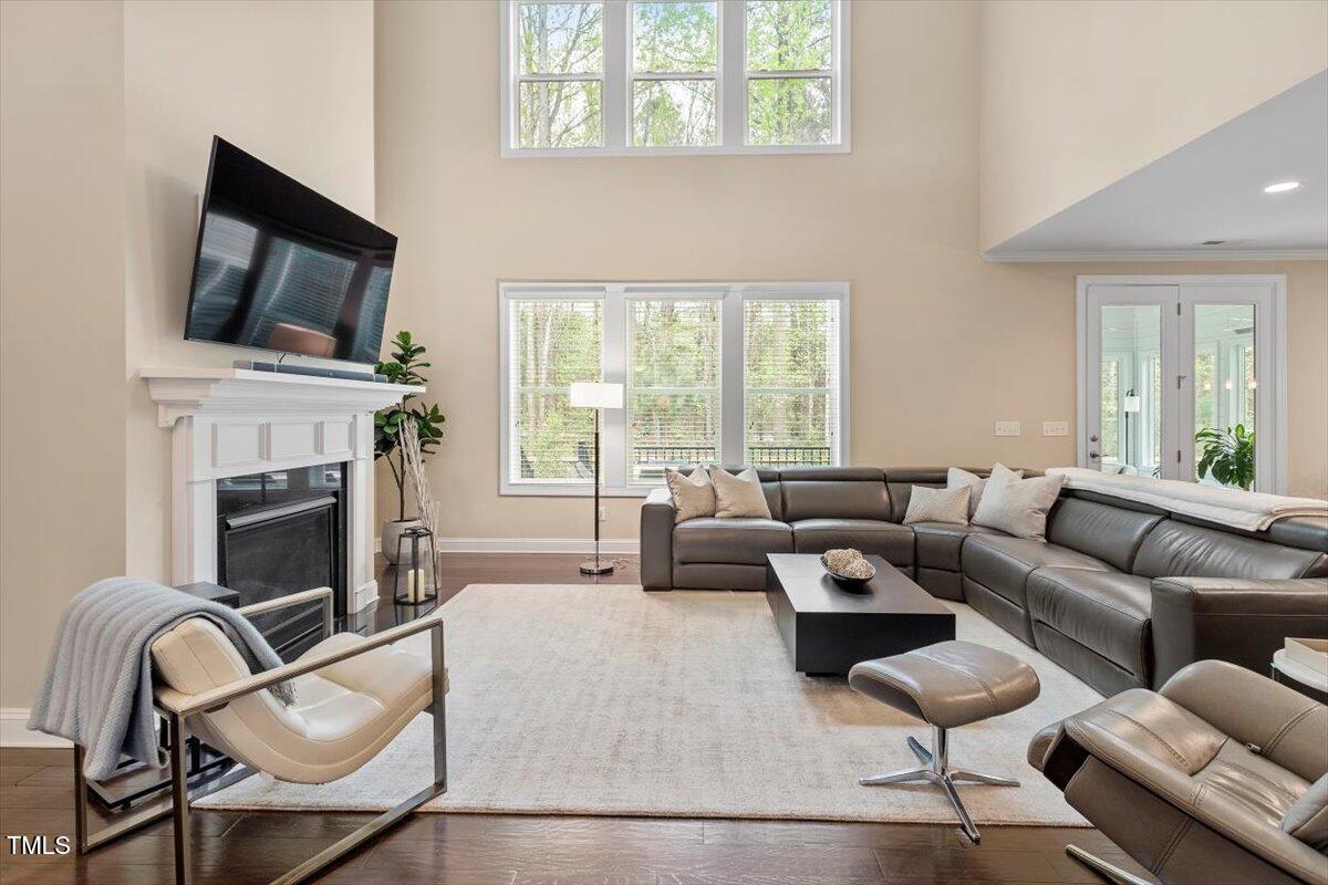 2421 Trenton Park Lane Raleigh, NC 27607 - Photo 17 of 66 a living room with furniture a fireplace and a flat screen tv