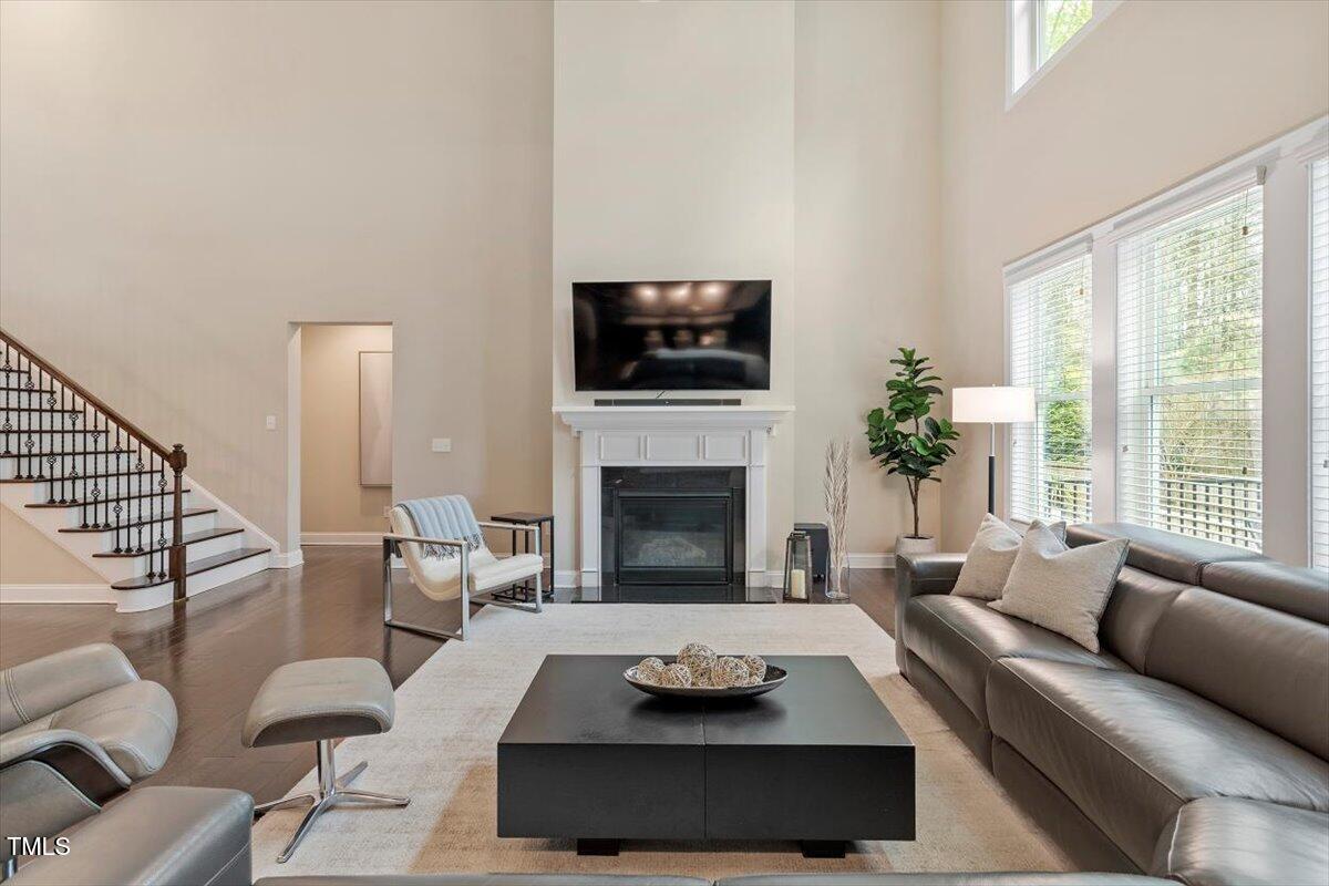 2421 Trenton Park Lane Raleigh, NC 27607 - Photo 19 of 66 a living room with furniture a flat screen tv and a fireplace