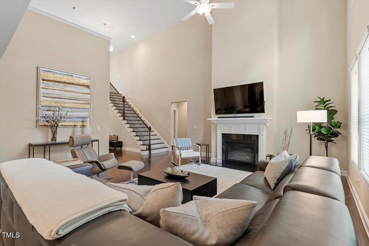 2421 Trenton Park Lane Raleigh, NC 27607 - Photo 20 of 66 a living room with furniture a fireplace and a flat screen tv