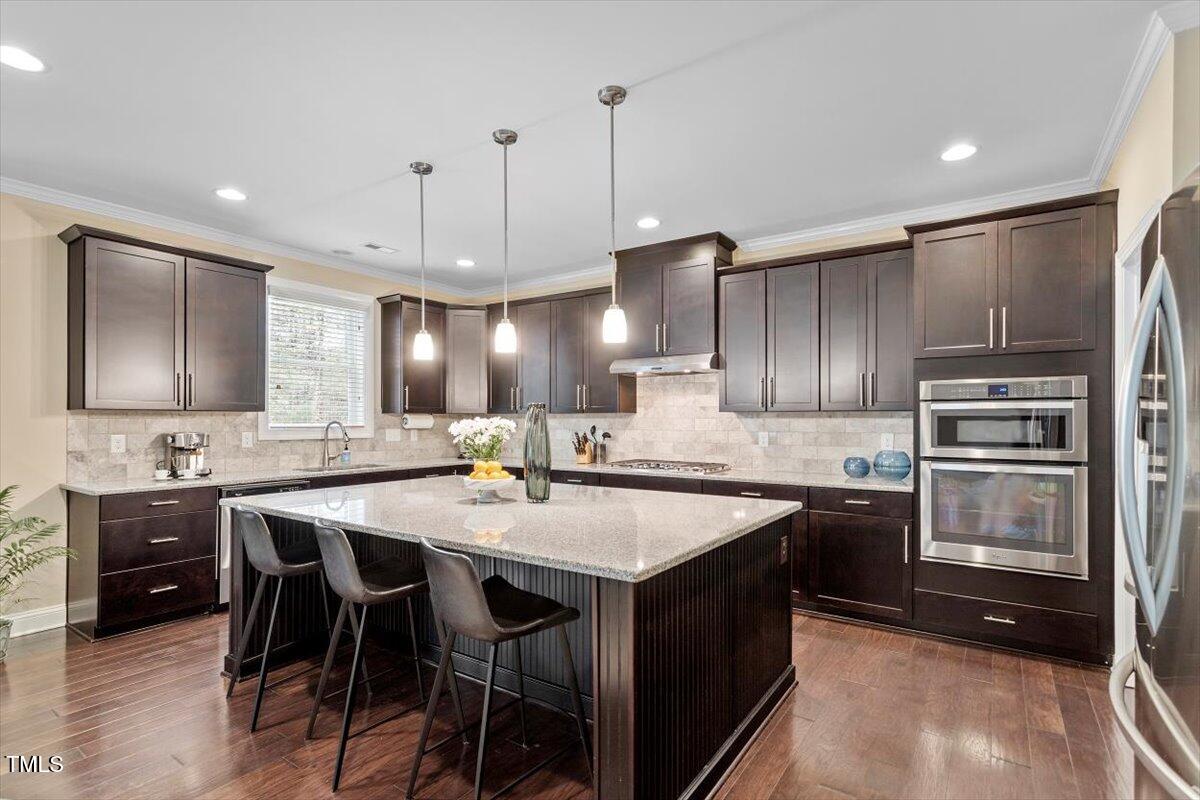 2421 Trenton Park Lane Raleigh, NC 27607 - Photo 24 of 66 a kitchen with stainless steel appliances a sink stove and refrigerator
