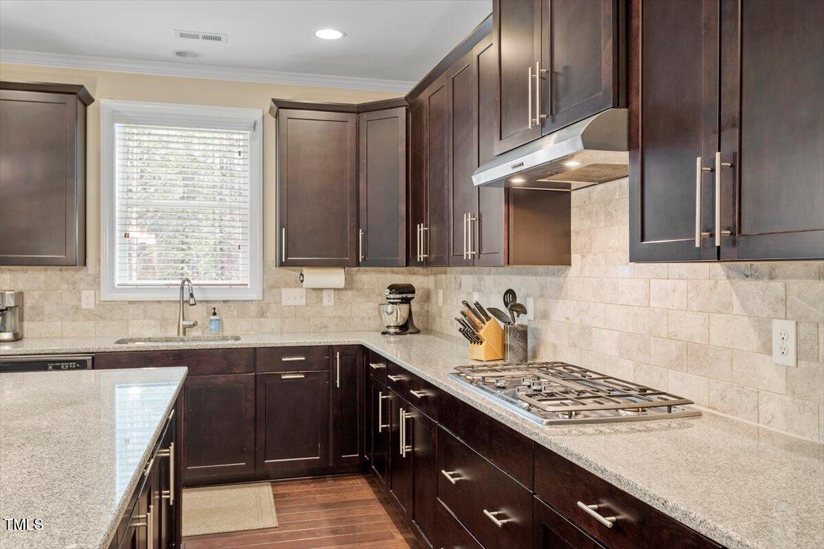 2421 Trenton Park Lane Raleigh, NC 27607 - Photo 25 of 66 a kitchen with a sink stove top oven and cabinets
