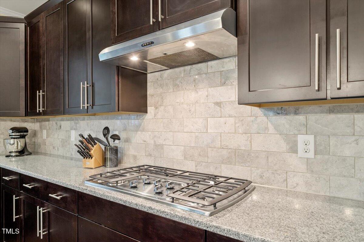 2421 Trenton Park Lane Raleigh, NC 27607 - Photo 27 of 66 a kitchen with stainless steel appliances a stove a sink and cabinets