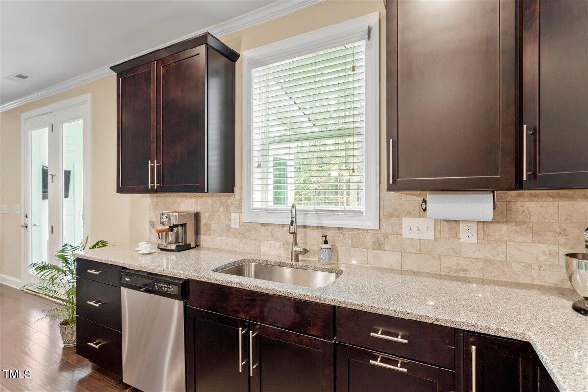 2421 Trenton Park Lane Raleigh, NC 27607 - Photo 28 of 66 a sink with granite countertop cabinets and window