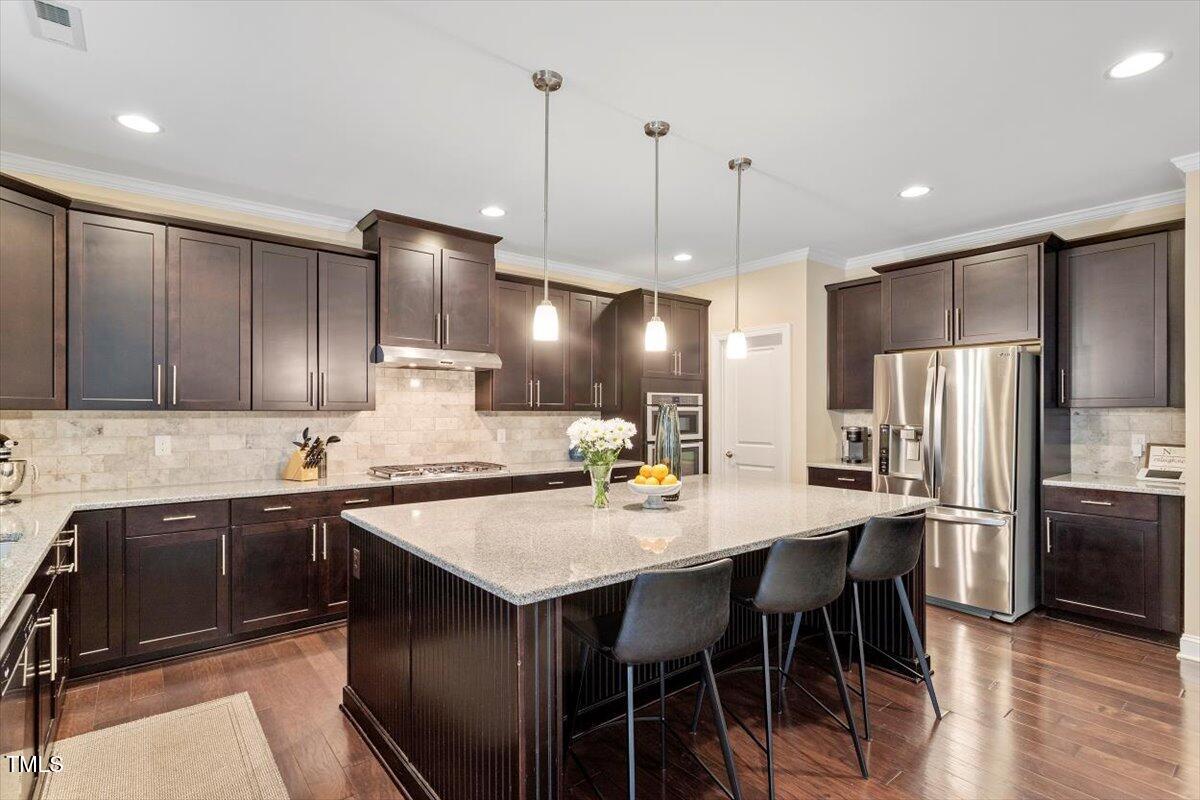 2421 Trenton Park Lane Raleigh, NC 27607 - Photo 32 of 66 a kitchen with stainless steel appliances a sink stove and refrigerator