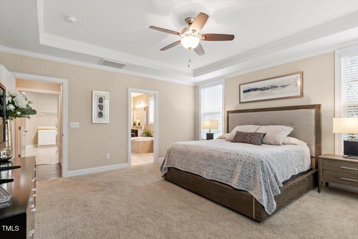 2421 Trenton Park Lane Raleigh, NC 27607 - Photo 35 of 66 a bedroom with a large bed and a chandelier