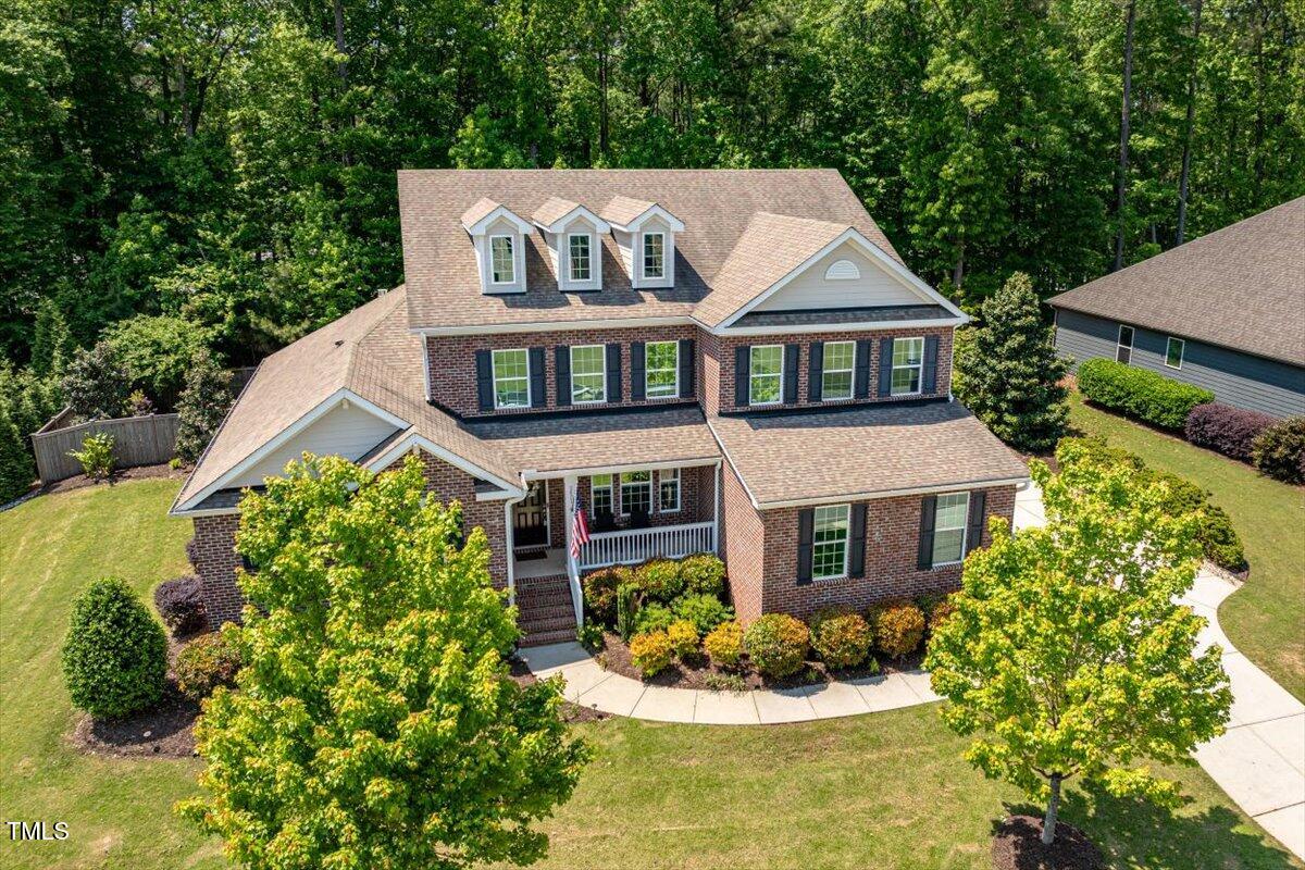 2421 Trenton Park Lane Raleigh, NC 27607 - Photo 59 of 66 a front view of a house with a yard and fountain in middle