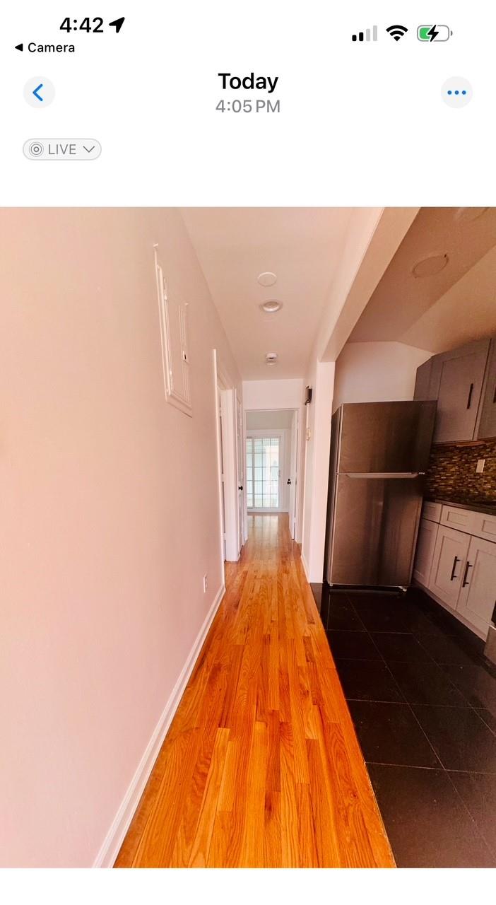 104-65 Springfield Boulevard Queens, NY 11429 - Photo 17 of 23 a view of a living room with a wooden floor