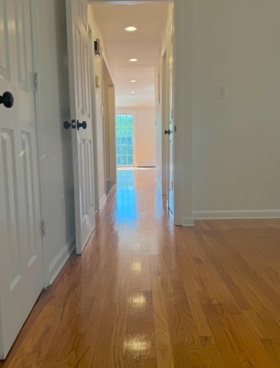 104-65 Springfield Boulevard Queens, NY 11429 - Photo 21 of 23 a view of a hallway with wooden floor