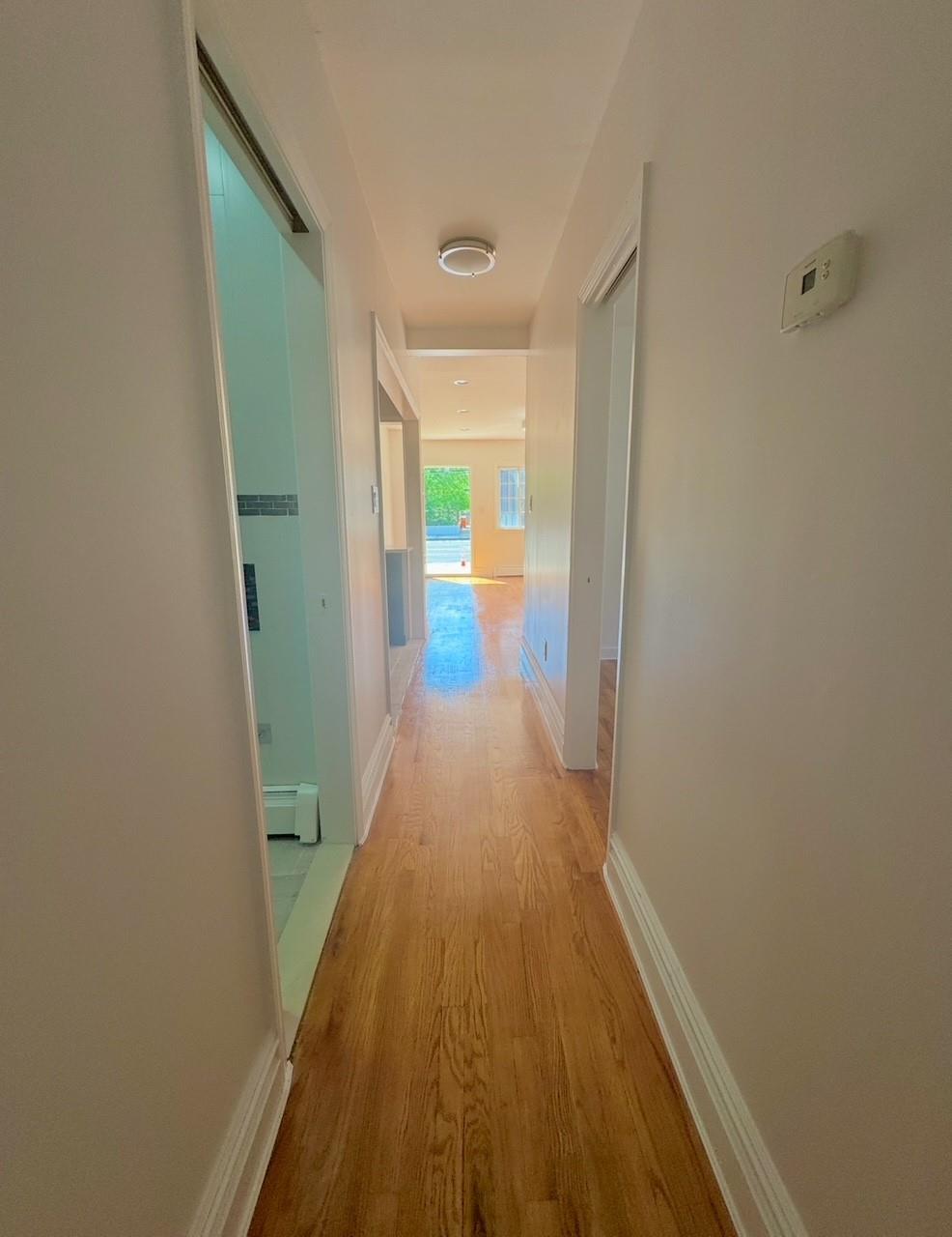 104-65 Springfield Boulevard Queens, NY 11429 - Photo 22 of 23 a view of a hallway with wooden floor