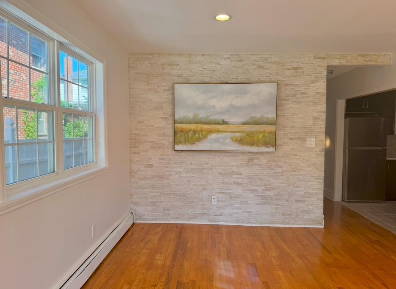 104-65 Springfield Boulevard Queens, NY 11429 - Photo 6 of 23 a view of a livingroom with wooden floor and a large window