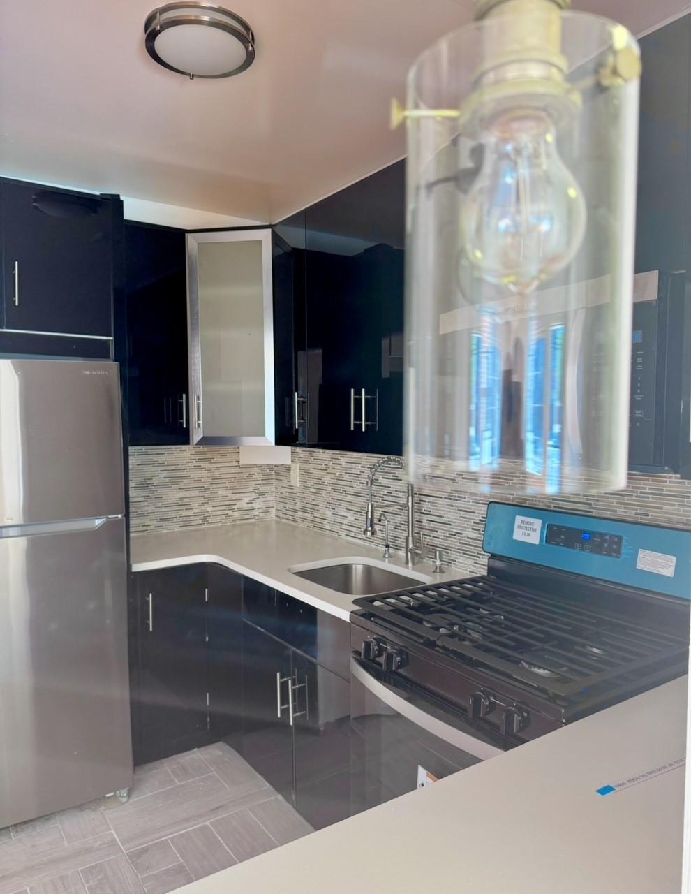 104-65 Springfield Boulevard Queens, NY 11429 - Photo 9 of 23 a bathroom with a sink and a mirror